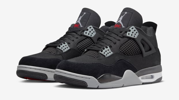 View of black and grey Air Jordan 4 shoes.